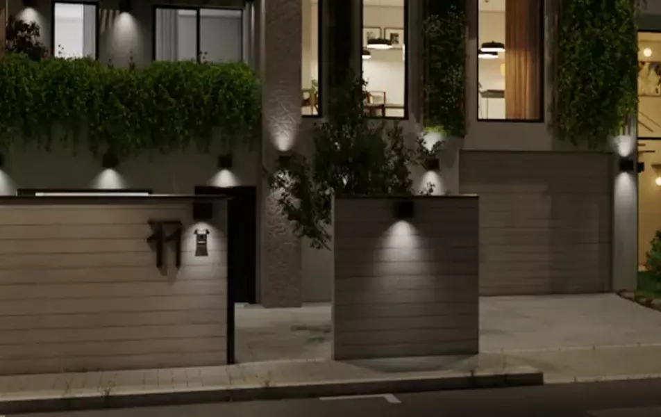 render nocturno exterior de una vivienda unifamiliar gris con cochera y jardín